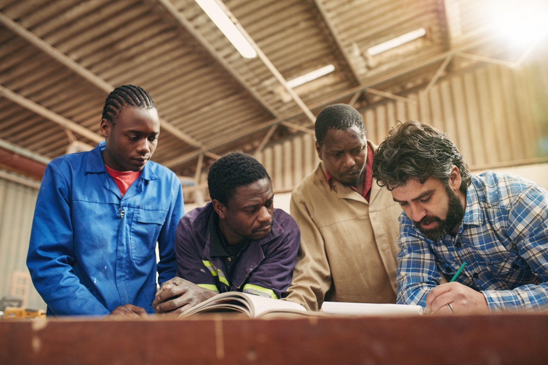 A group of carpenters looking together at plans